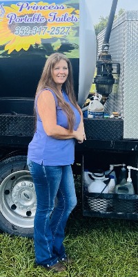 Princess Katey standing in front of Princess Portable Toilet Truck