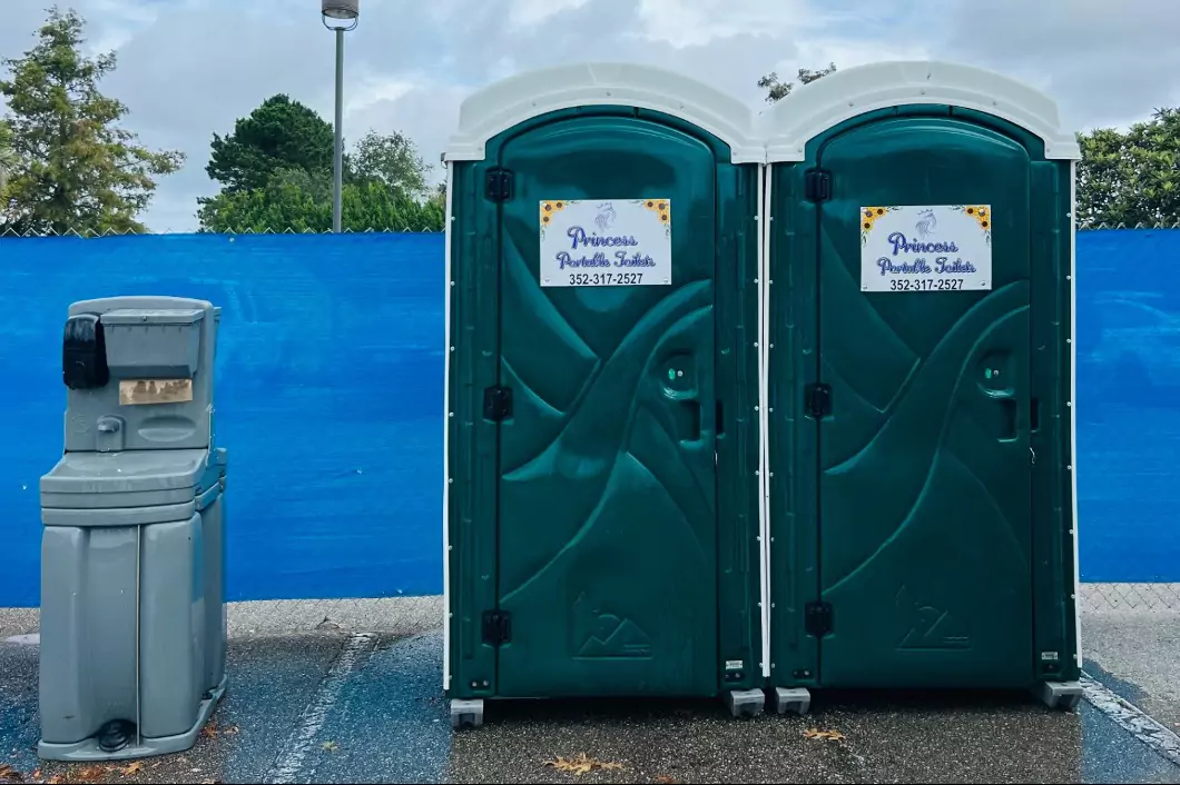 Princess Portable Toilets with handwashing station placed outdoors