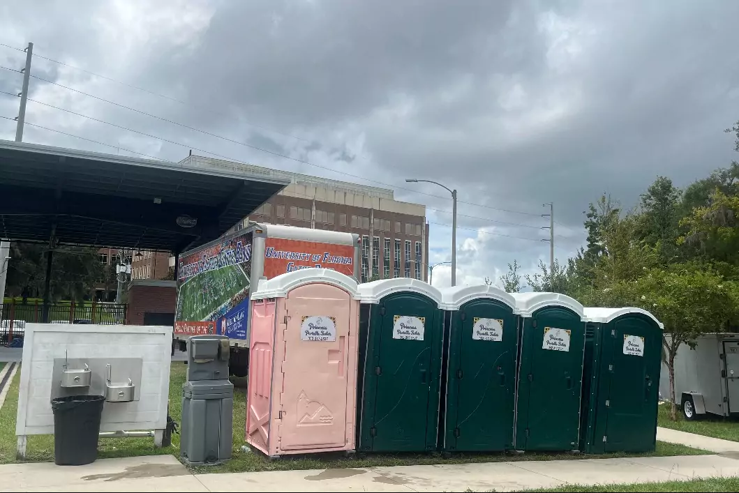 Princess Portable Toilets with trees and buildings on the background