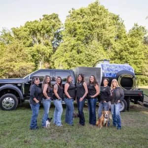 Princess Portable Toilets staff pose with their service truck, representing punctual, clean, and professional sanitation service
