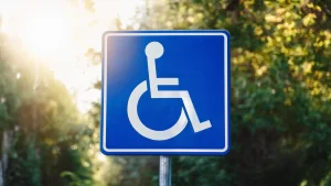 A blue disabled person icon sign symbolizing handicap accessible portable toilets for inclusive emergency relief efforts