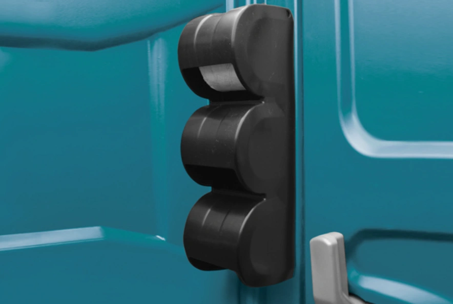 Interior close-up of the vertical paper guard protecting toilet paper from moisture