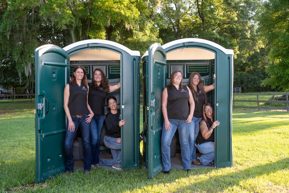Princess PortableToilets all woman team in green porta potties